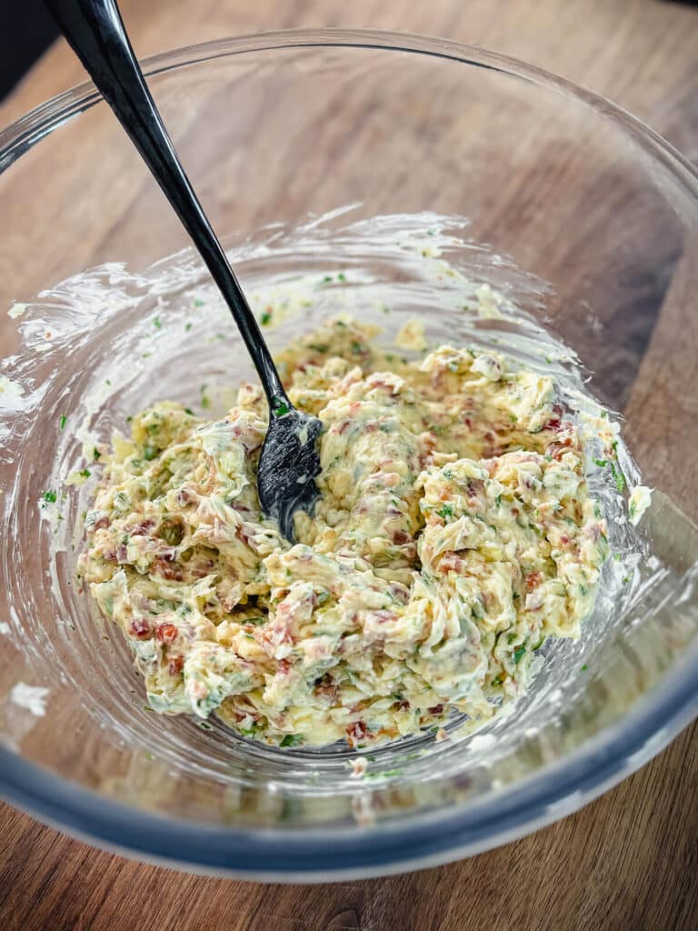 bacon butter mixed in a medium sized mixing bowl