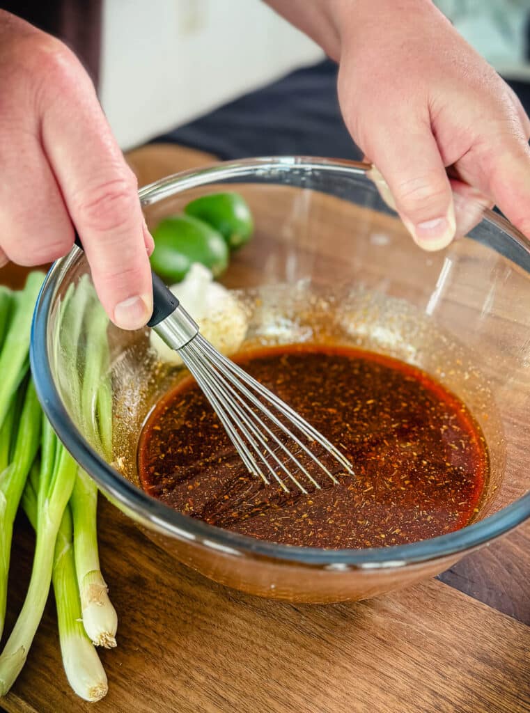 whisk mixing up Peruvian chicken marinade