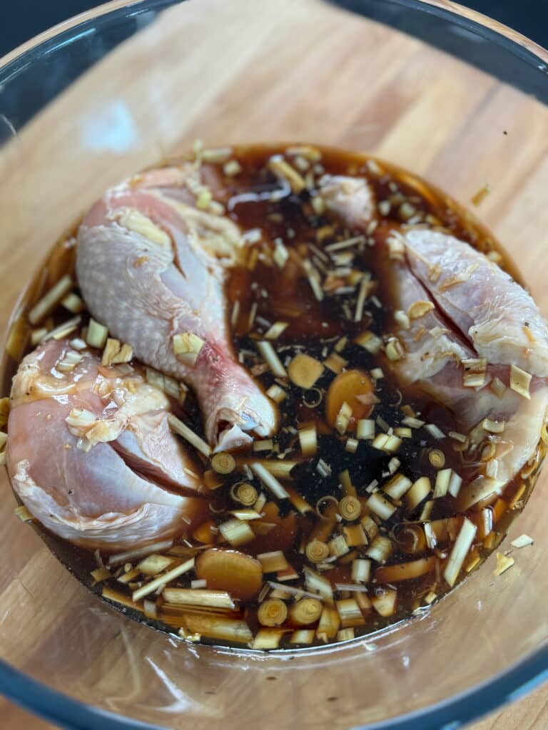 chicken quarters being marinated for chicken Inasal