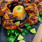 chicken inasal on a platter with limes