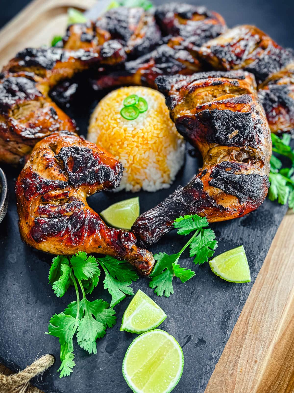 chicken Inasal with limes on a platter