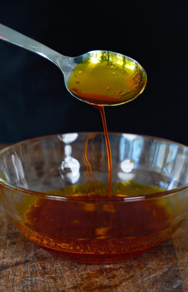 chicken oil being drizzled from a spoon