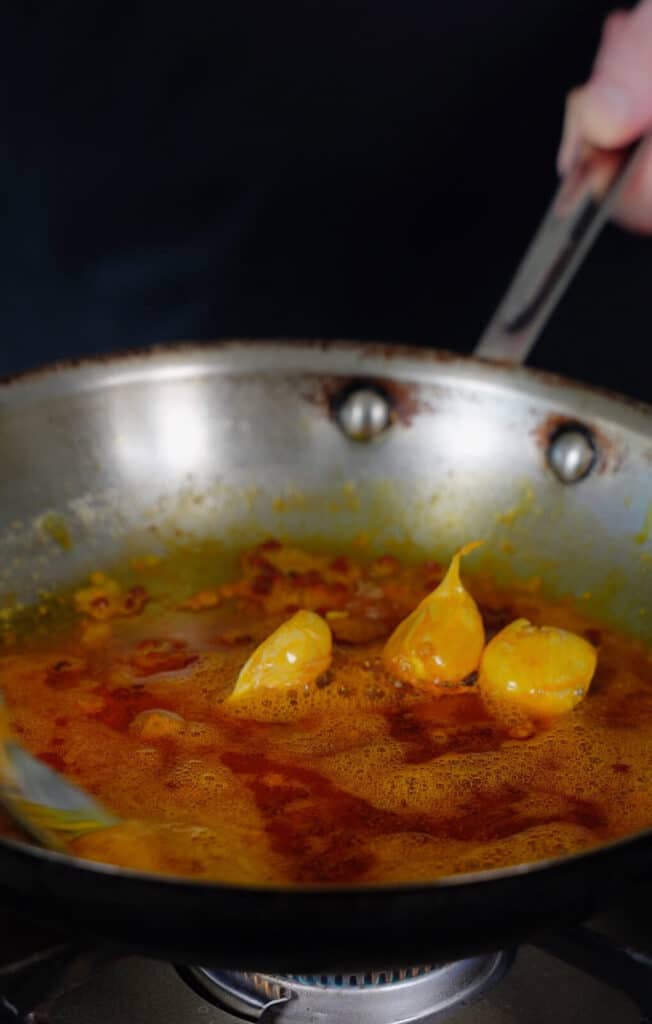chicken oil with garlic in a frying pan