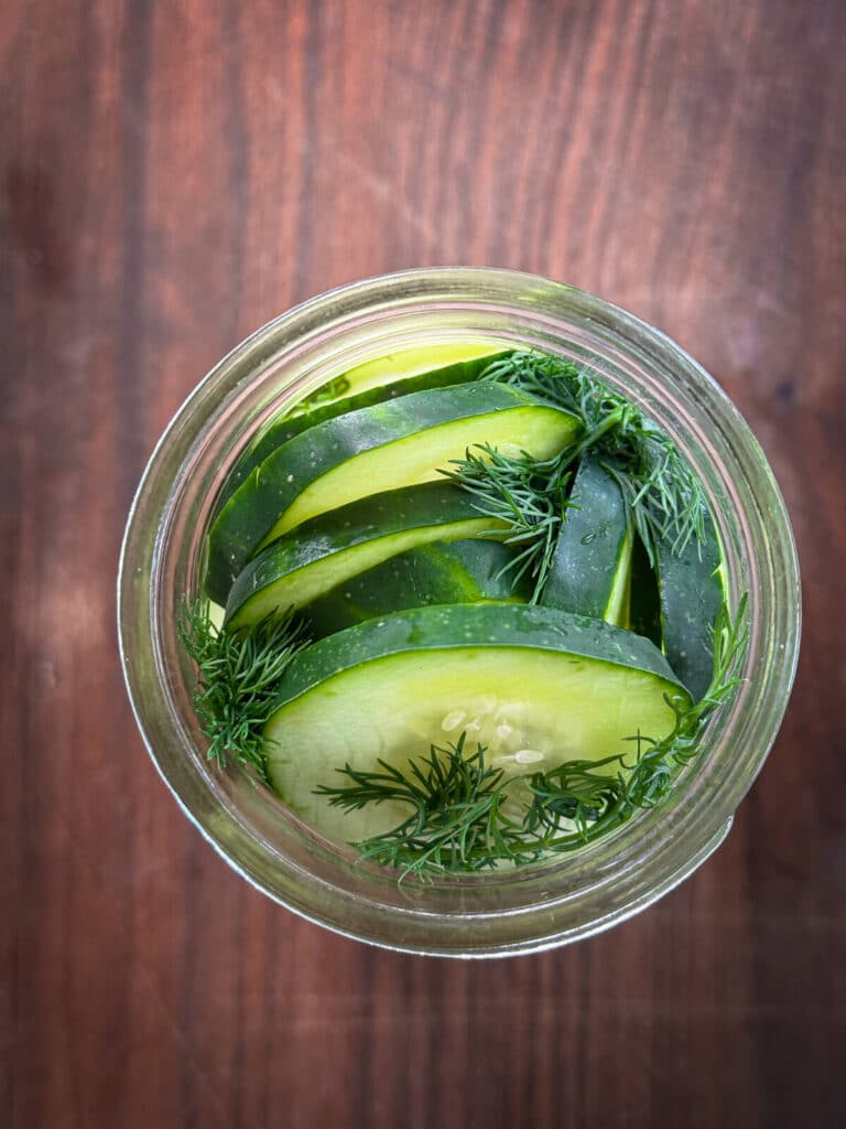 cucumbers and dill in a glass jar