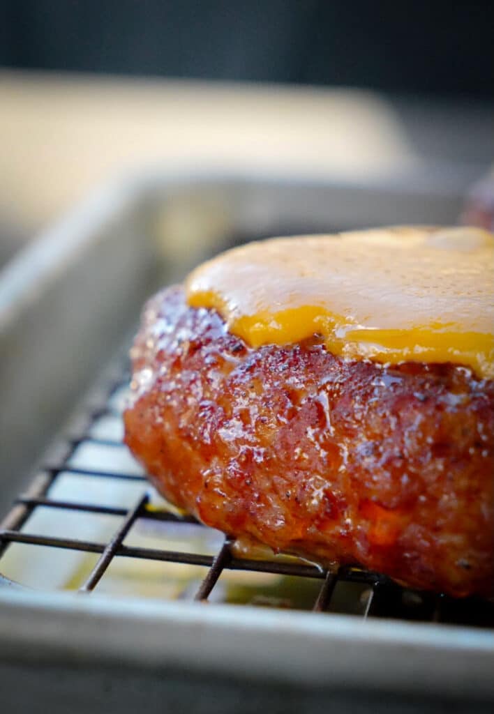 melted cheese on a pork burger patty