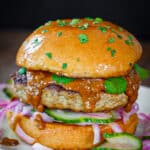 Indian butter chicken burgers on a white plate