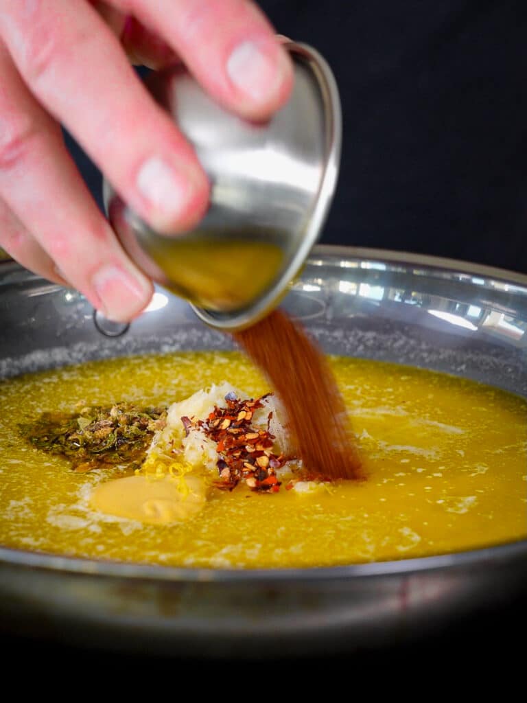 chipotle chili powder being added to cowboy butter