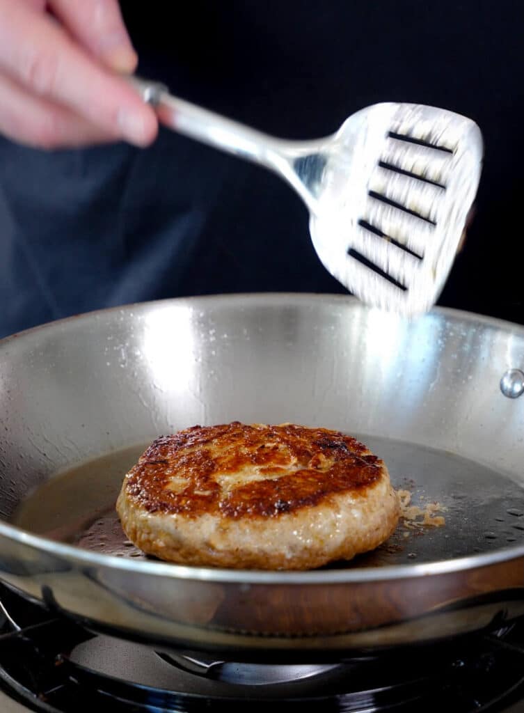 seared ground chicken patty in a pan