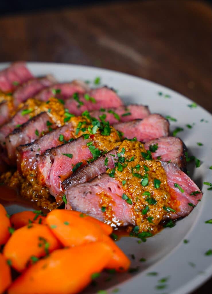 bandito butter drizzled on a medium rare sliced steak