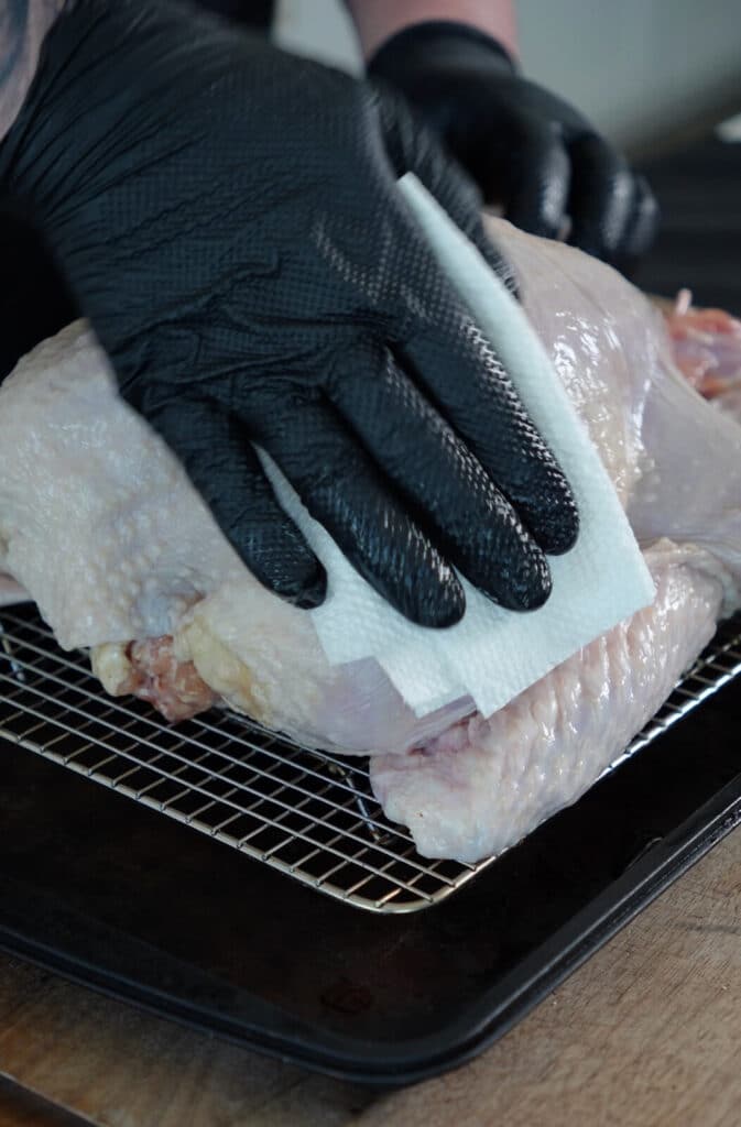 dabbing a turkey dry with a paper towel