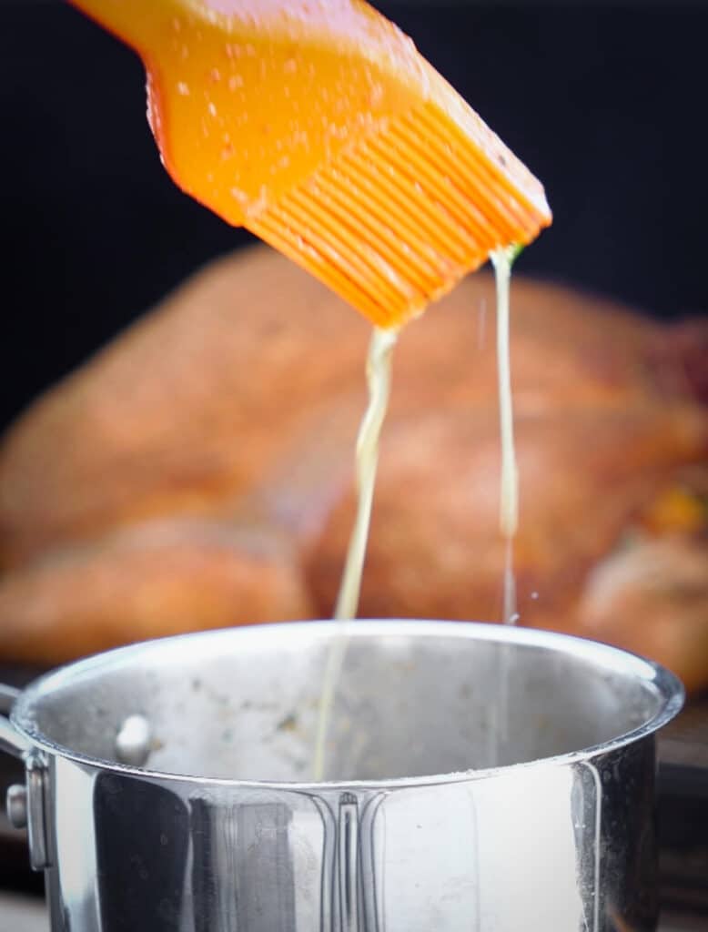 melted butter dripping off of a basting brush