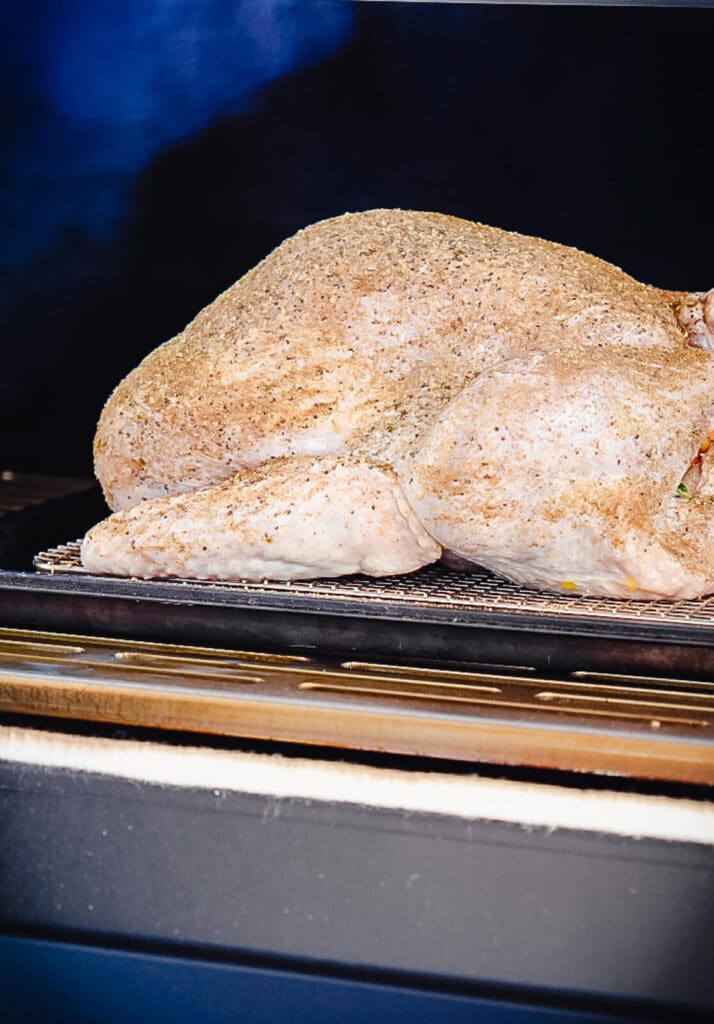 uncooked turkey inside of a smoker