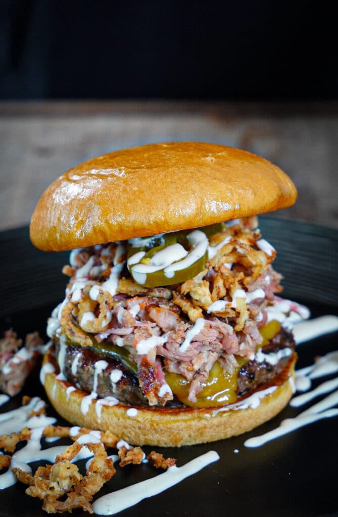 ranch hand burger on a black plate