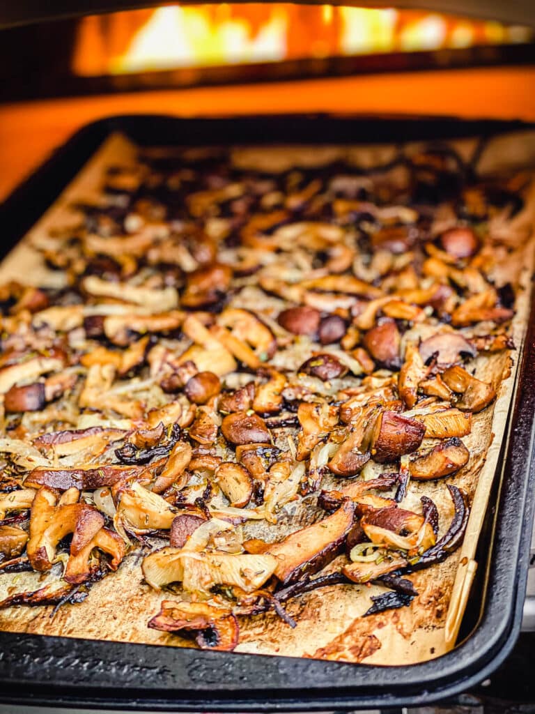 roasted mushrooms coming out of a pizza oven