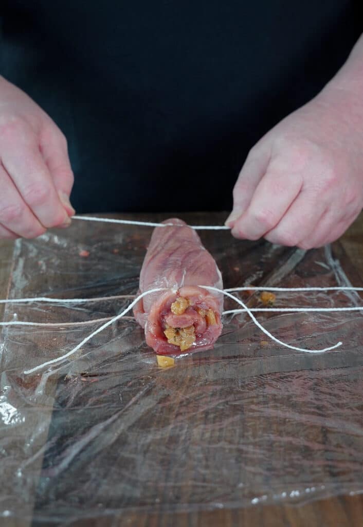 pork tenderloin being tied up