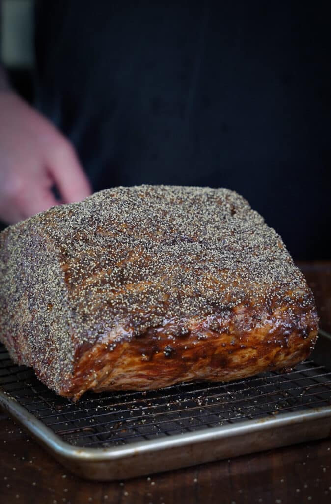 prime rib with pepper coating ready to be placed on a smoker