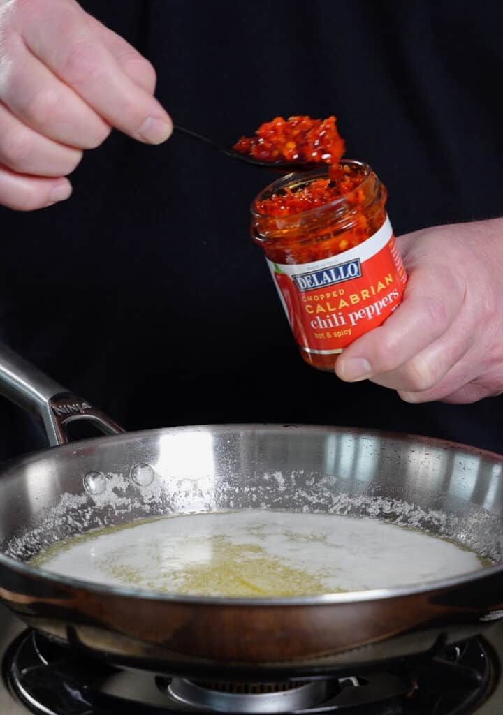 calabrian chili paste being added to melted butter