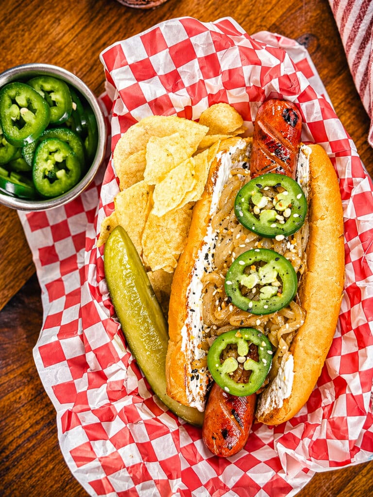 Seattle style hot dog with pickle spear