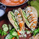 chicken tikka masala tacos on a wooden cutting board
