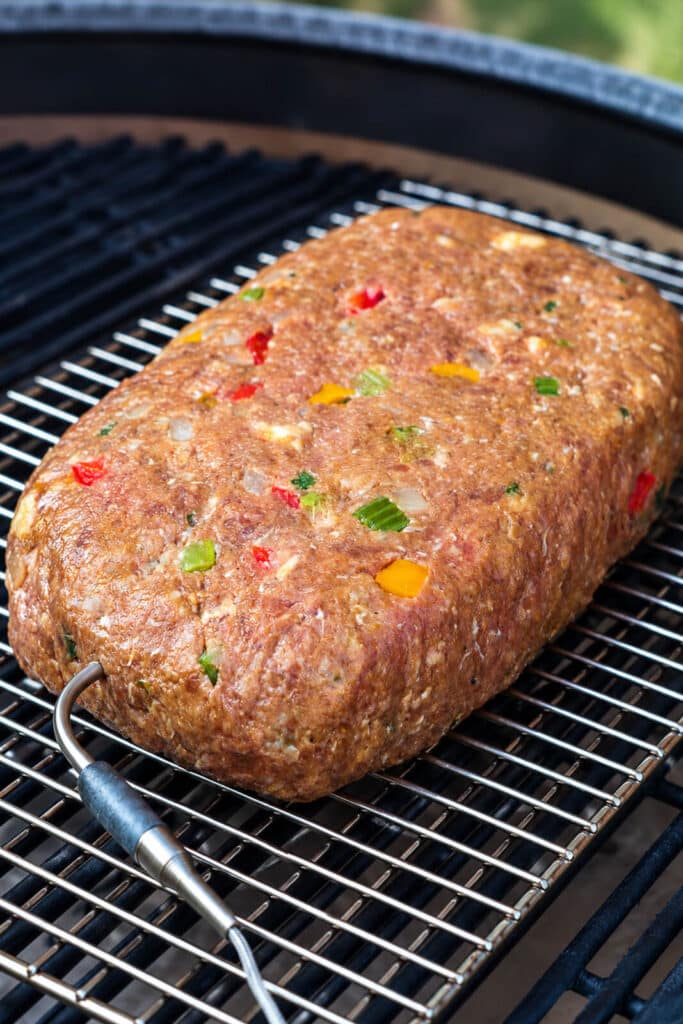 Italian meatloaf on a wire rack on a grill over indirect heat