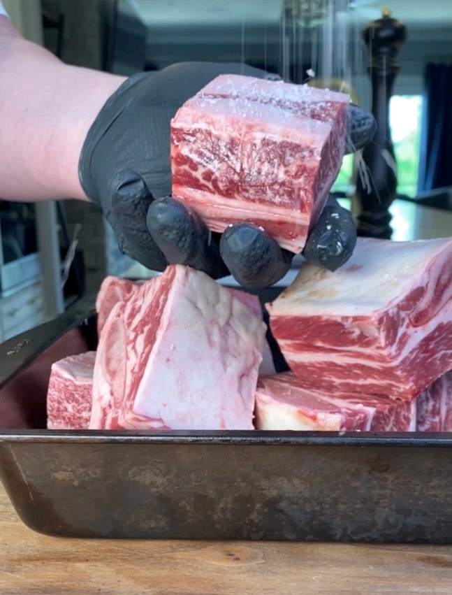 salt being added to English cut short ribs